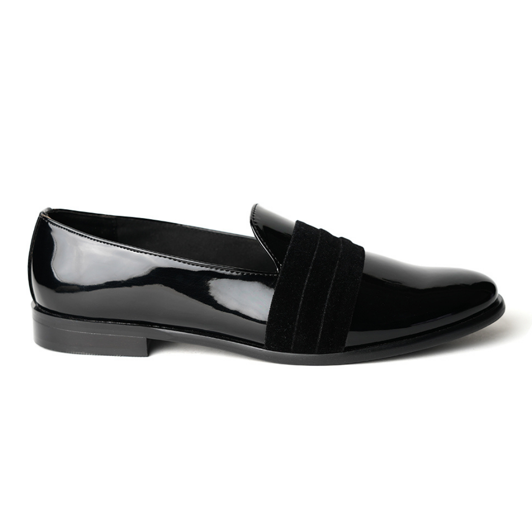 A black Tuxedo Slip-on with a patent leather finish and a bow on the side, by Monkstory.