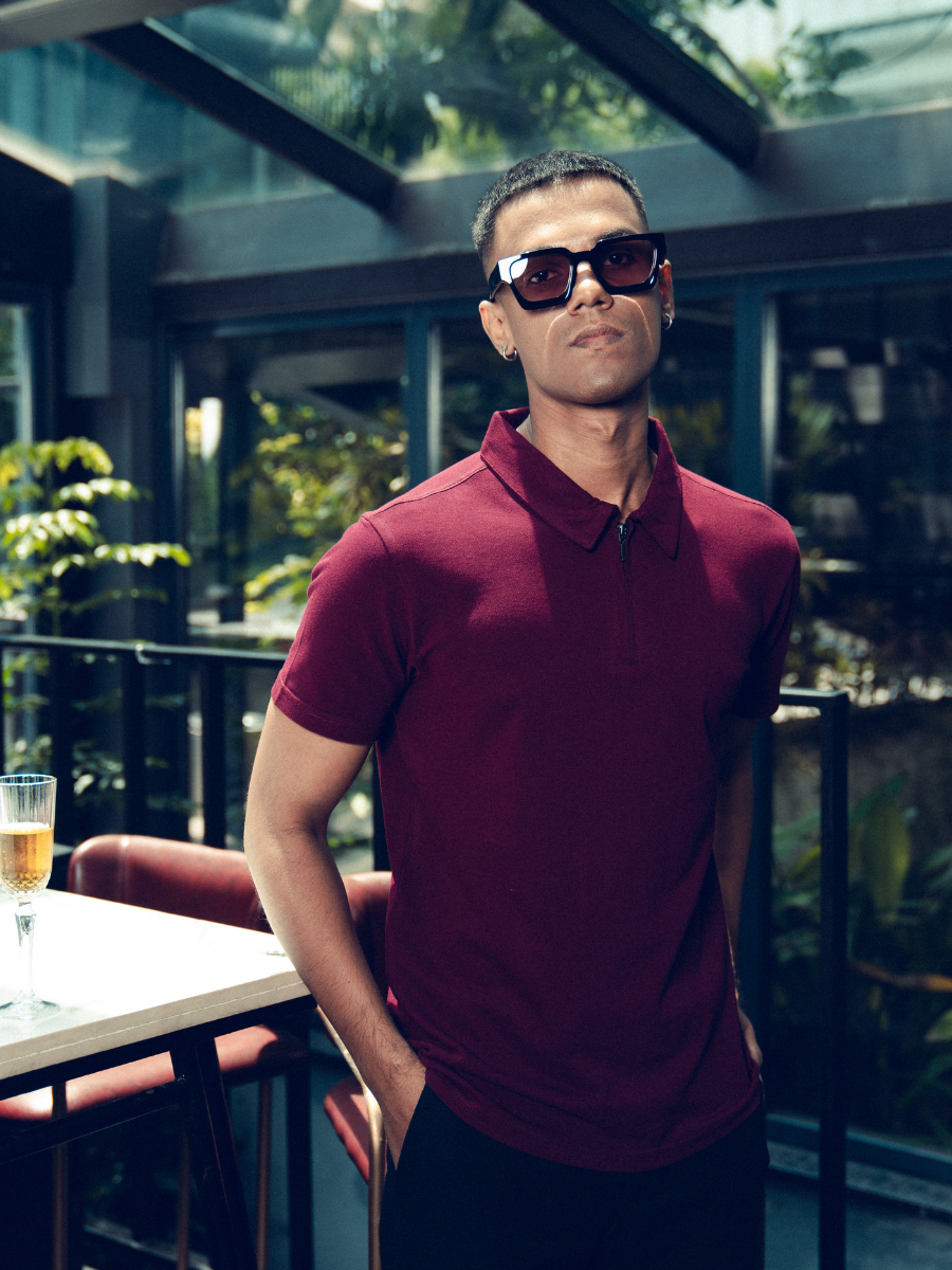 A man wearing a Monkstory Bamboo Cotton Zip-Polo Tee in Mauve Wine shade.