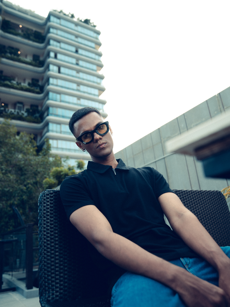 Monkstory young man posing in a Bamboo Cotton Zip-Polo Tee - Midnight Black.