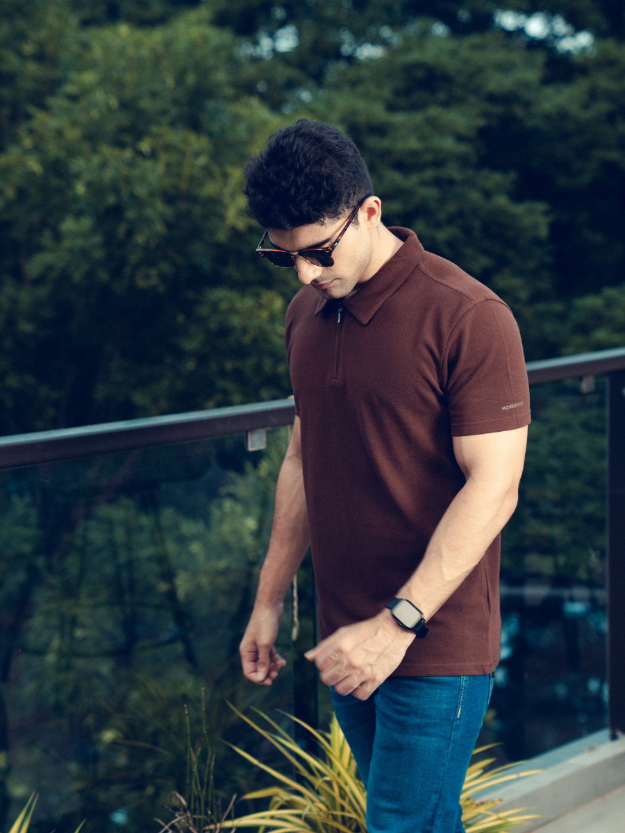 A man in a sophisticated Monkstory Bamboo Cotton Zip-Polo Tee, exuding comfort with his hands placed gently on his chest.