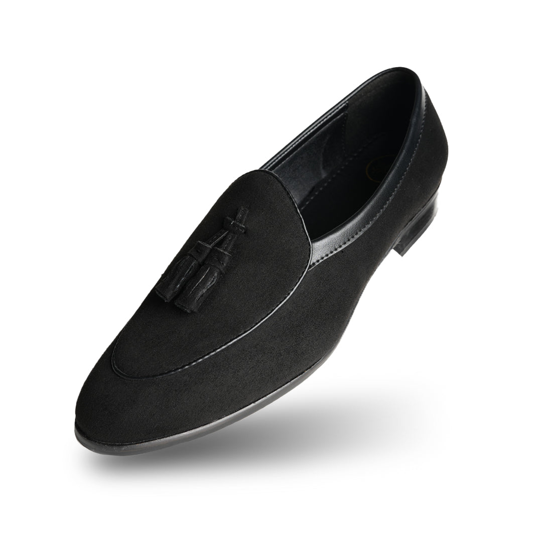 A Monkstory Tassel Slip-Ons - Black, a vegan leather loafer, with tassel on the side.