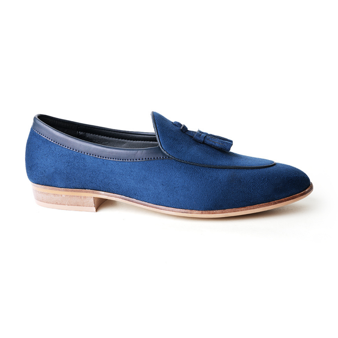 An eco-conscious blue suede Monkstory loafer with tassels, showcasing sustainability.