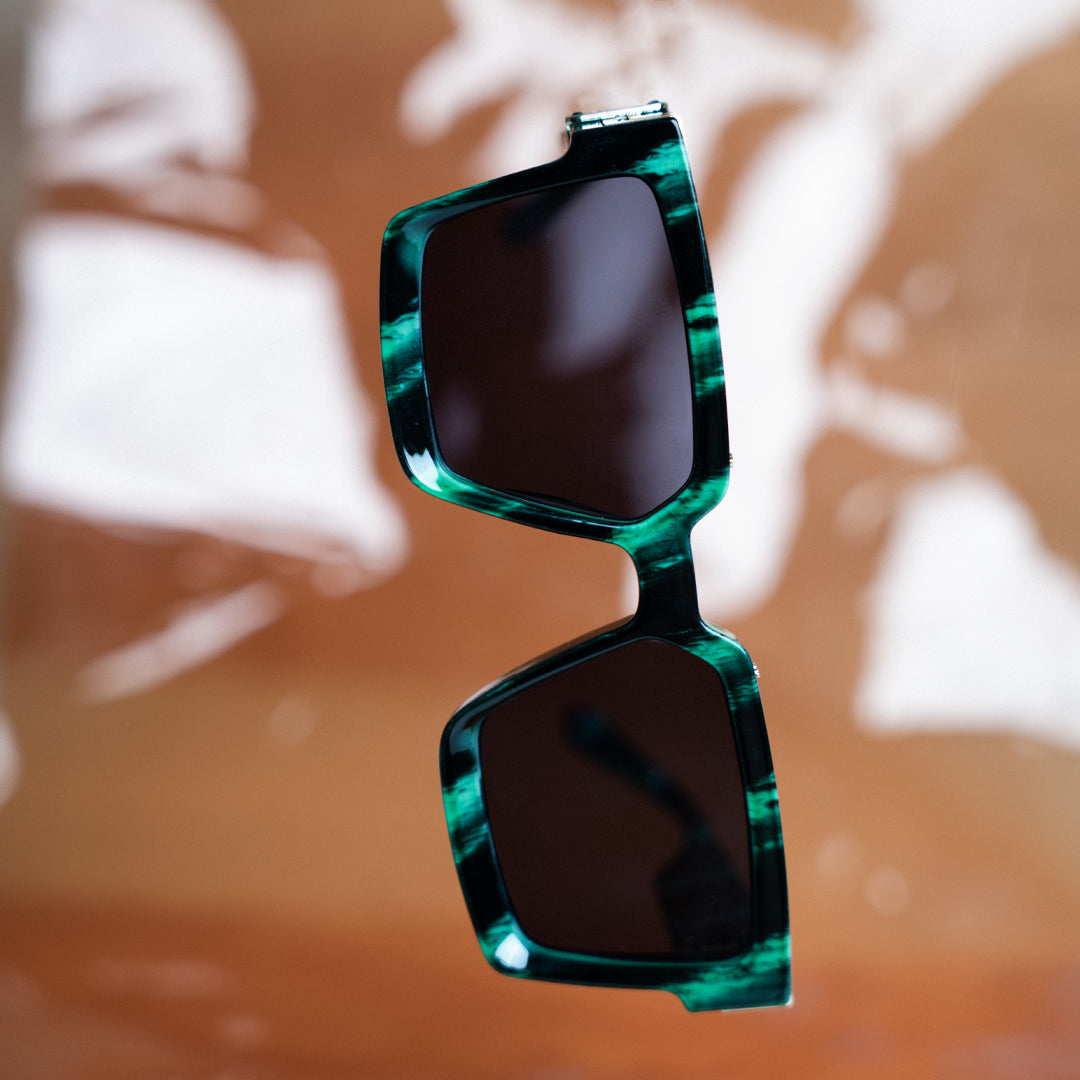 A green Monkstory Millionaire Unisex Wayfarer sunglasses with black lenses designed to protect against UV rays.