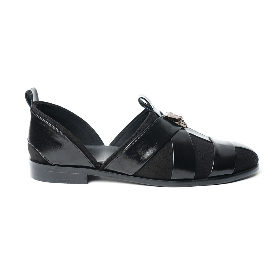 A sophisticated Monkstory Criss Cross Slip-On Sandal - Black leather shoe with straps.