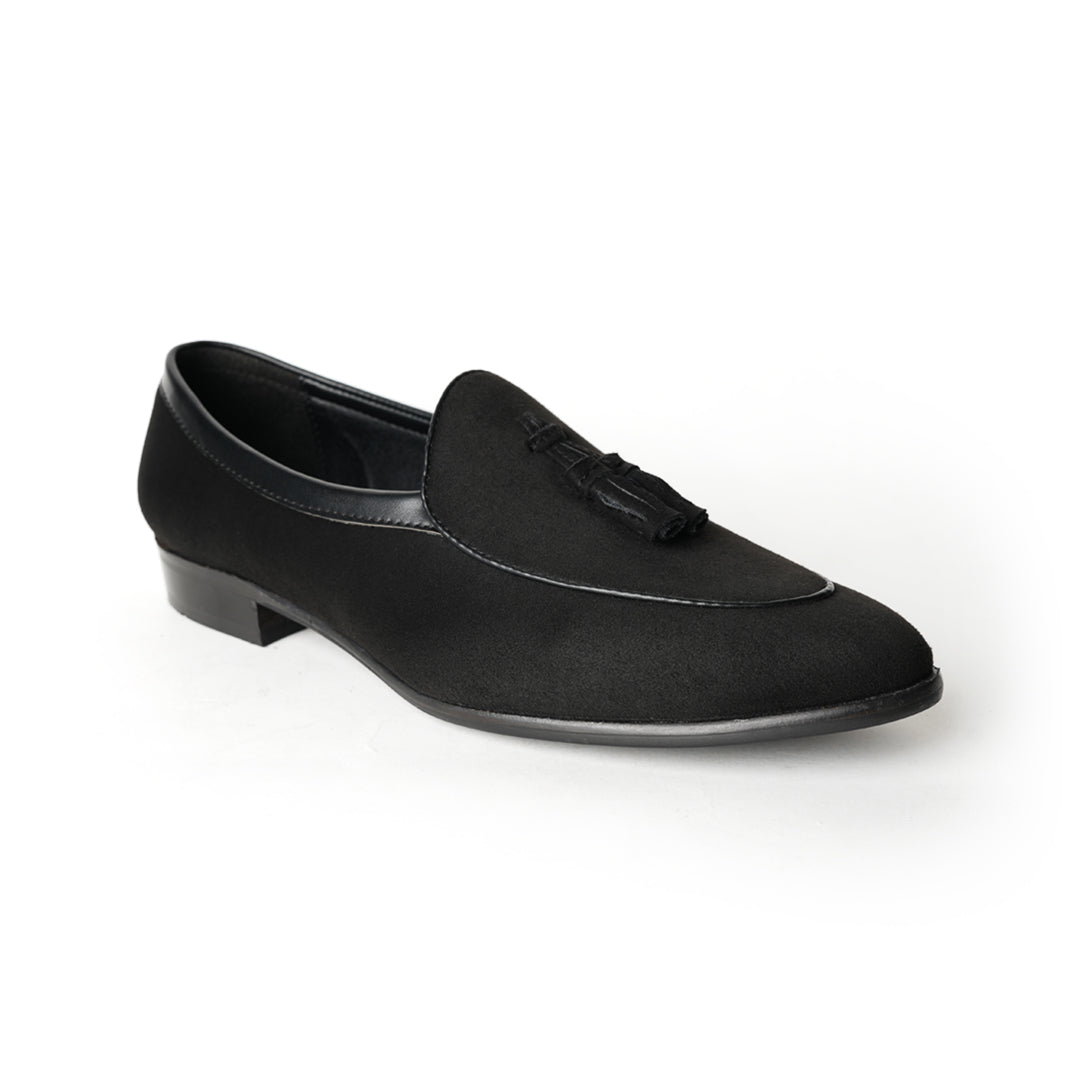 A Monkstory Tassel Slip-Ons - Black, a vegan leather loafer, with tassel on the side.