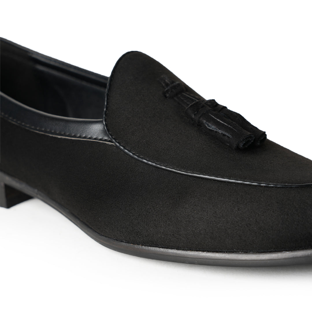 A Monkstory Tassel Slip-Ons - Black, a vegan leather loafer, with tassel on the side.