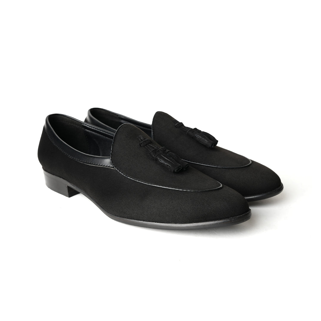 A Monkstory Tassel Slip-Ons - Black, a vegan leather loafer, with tassel on the side.