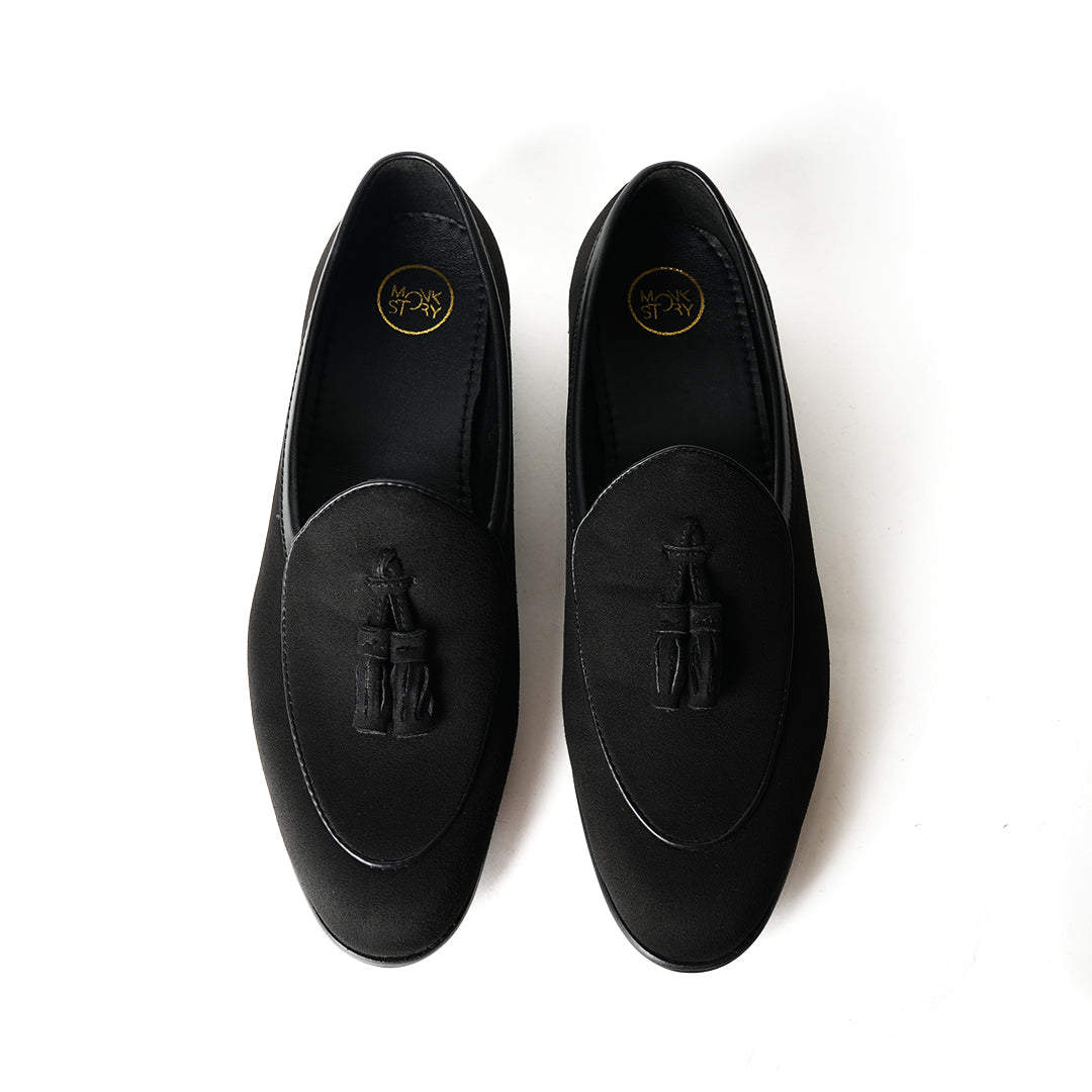 A Monkstory Tassel Slip-Ons - Black, a vegan leather loafer, with tassel on the side.