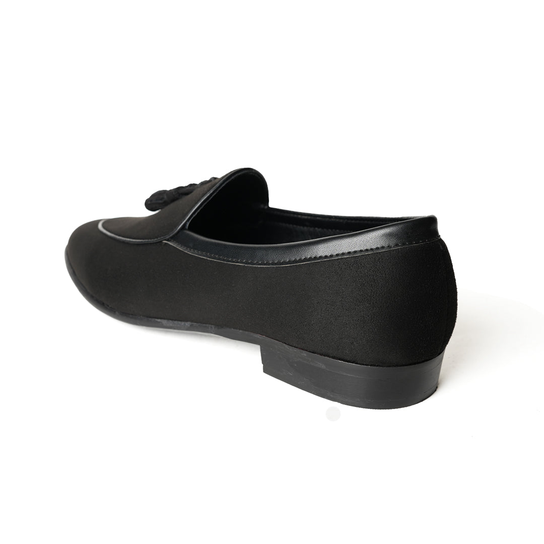 A Monkstory Tassel Slip-Ons - Black, a vegan leather loafer, with tassel on the side.