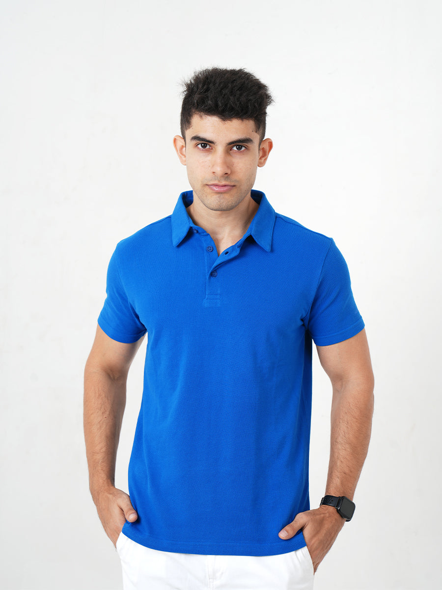 A man in a Monkstory Bamboo Cotton Polo Tee - Cobalt Blue posing for a photo, showcasing the breathable comfort and softness of the fabric.