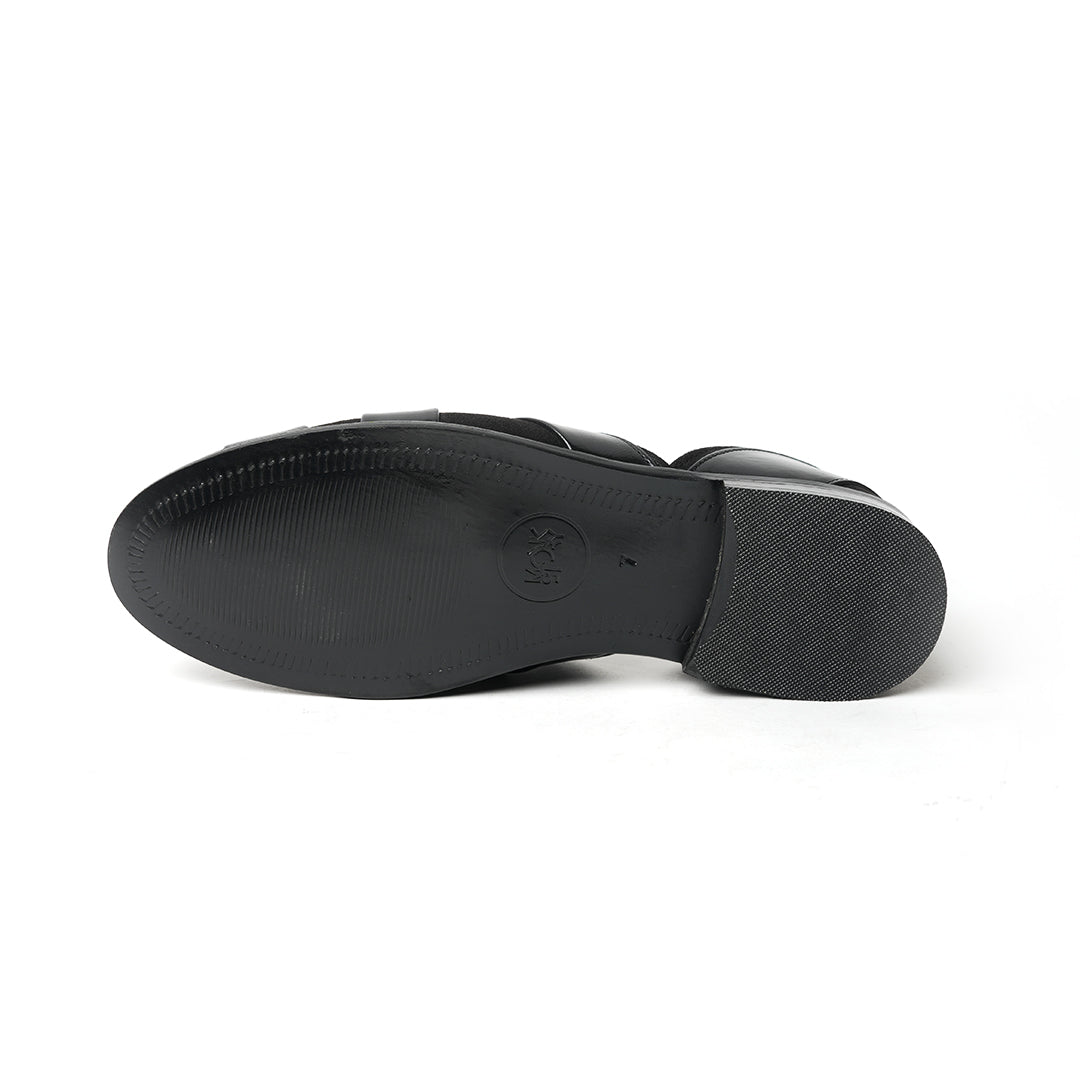 A sophisticated Monkstory Criss Cross Slip-On Sandal - Black leather shoe with straps.