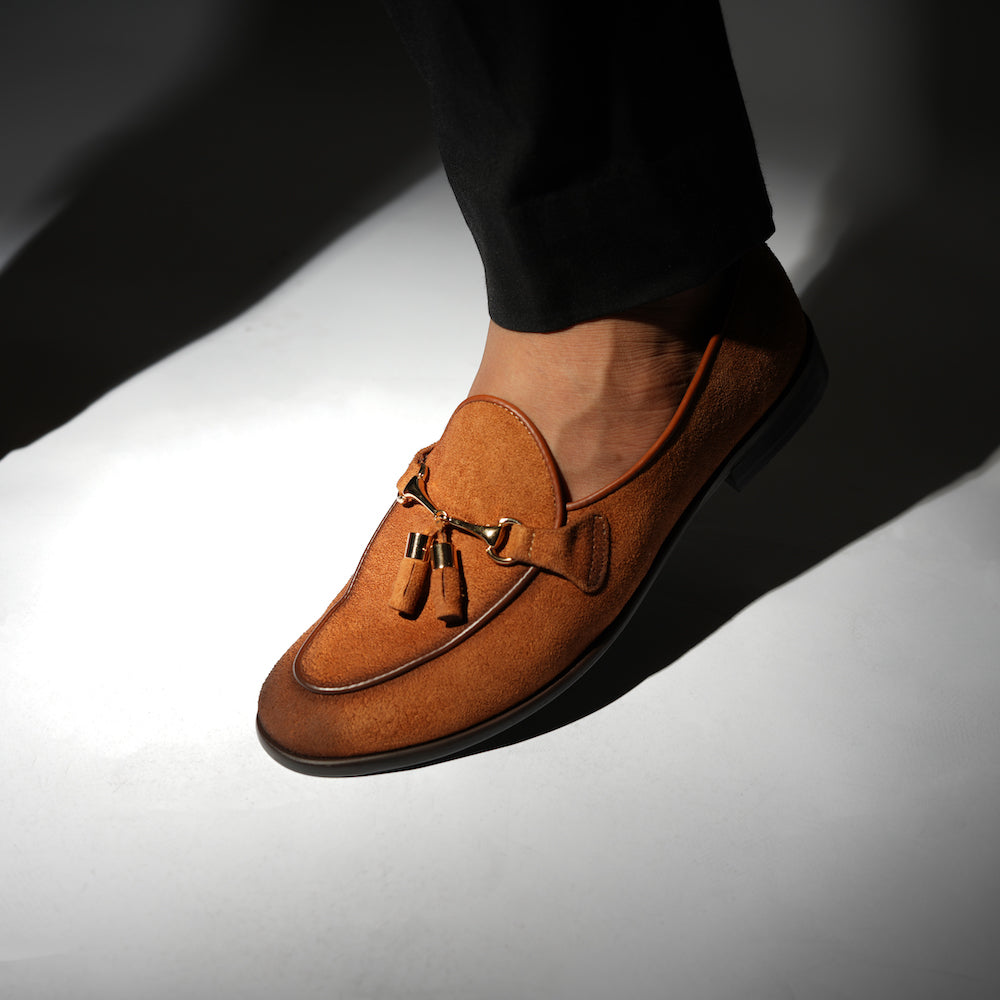 A rustic tan suede loafer, Monkstory Horse-bit Tasseled Slip-Ons - Rustic Tan, with timeless elegance.