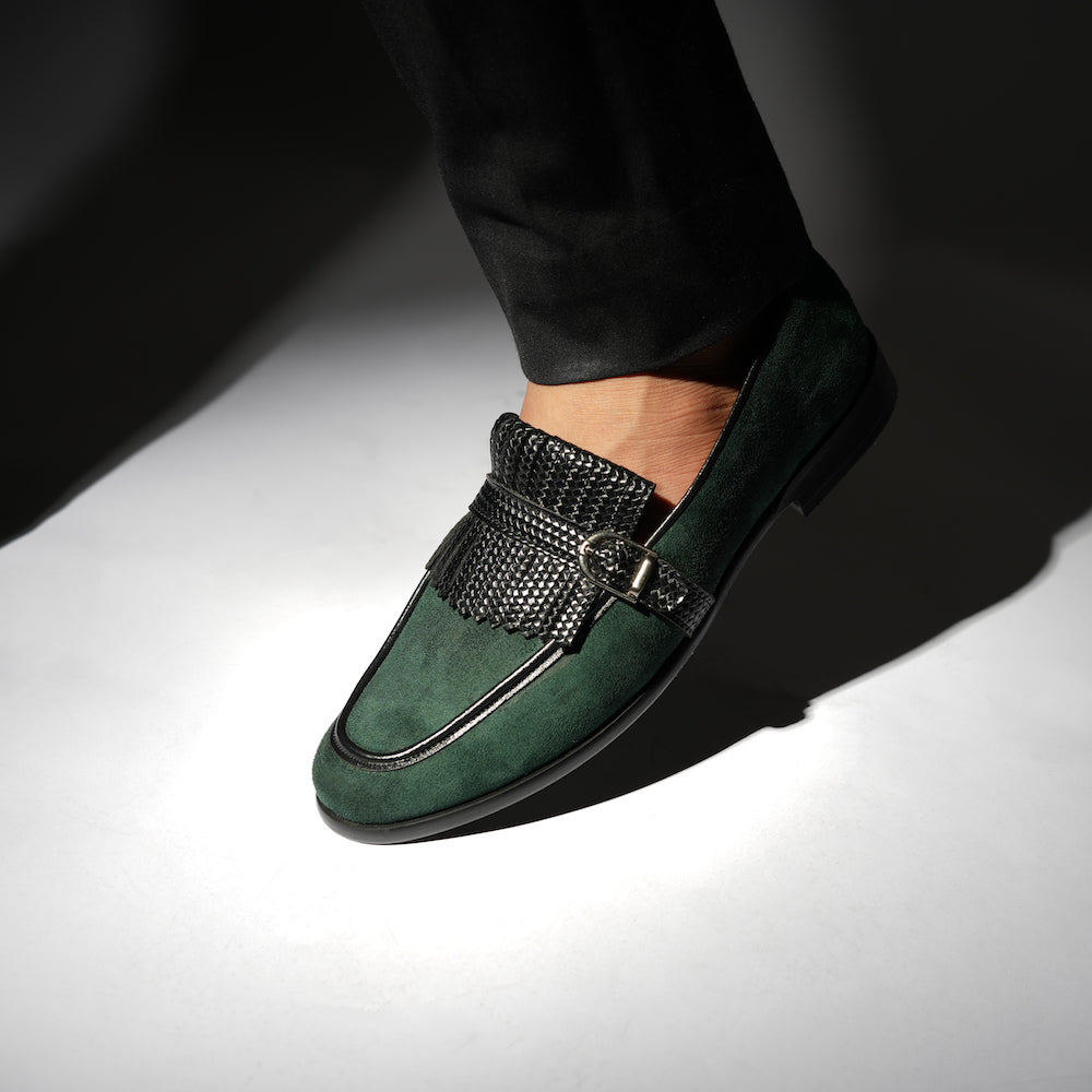 A Monkstory woven fringed slip-on with a bottle green suede and black buckle.