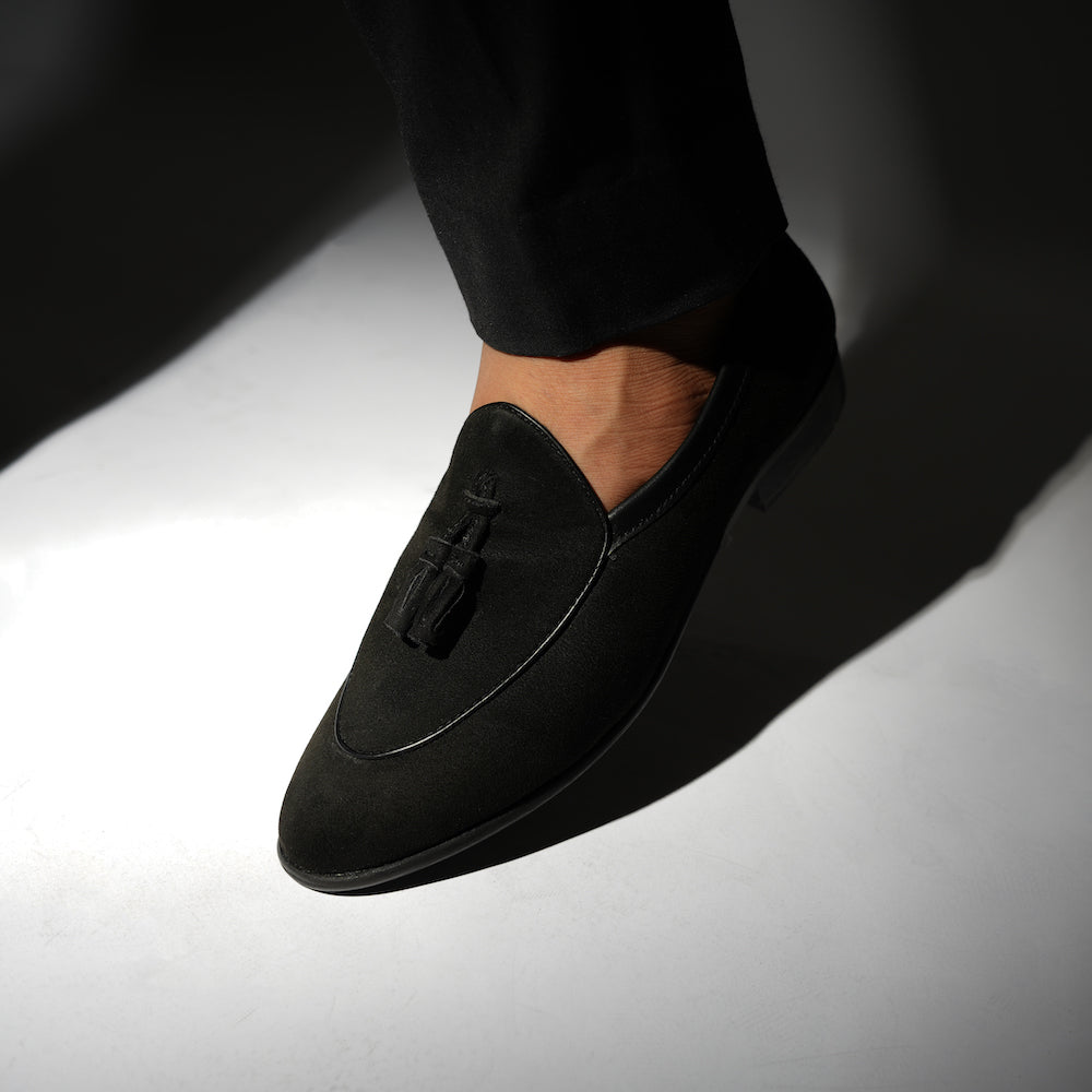 A Monkstory Tassel Slip-Ons - Black, a vegan leather loafer, with tassel on the side.