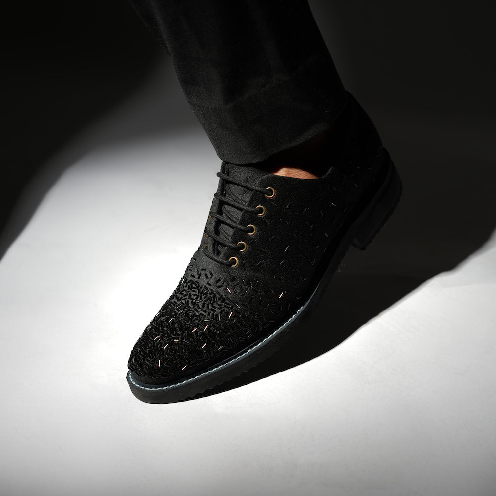 A stylish Monkstory Artisan Lace-Up - Black adorned with sequins, showcasing exquisite craftsmanship.