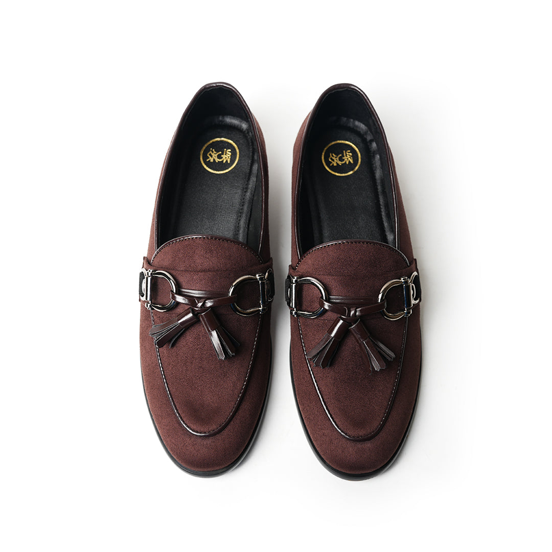 A timeless Monkstory brown loafer with tassels and a buckle, exuding modern sophistication.