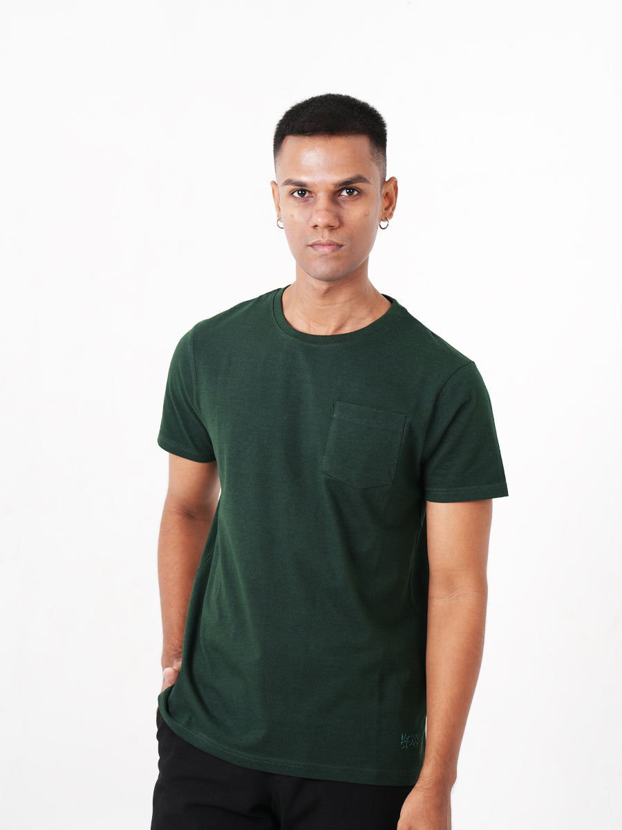 A man wearing a Monkstory Bamboo Cotton Crew Tee - Bottle Green with a pocket.