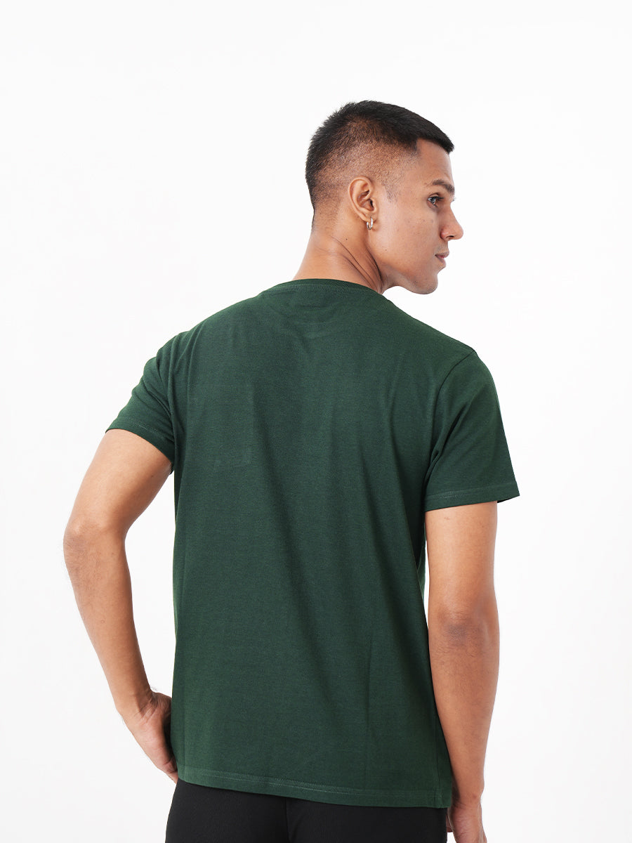 A man wearing a Monkstory Bamboo Cotton Crew Tee - Bottle Green with a pocket.