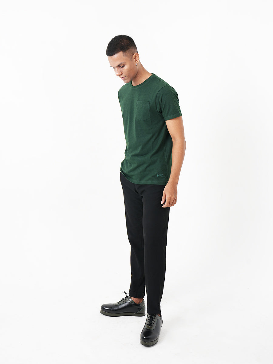 A man wearing a Monkstory Bamboo Cotton Crew Tee - Bottle Green with a pocket.