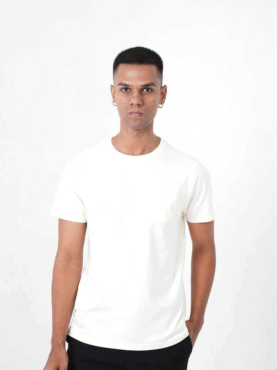 A man in a Monkstory Bamboo Cotton Crew Tee - Warm Ivory posing for a photo.
