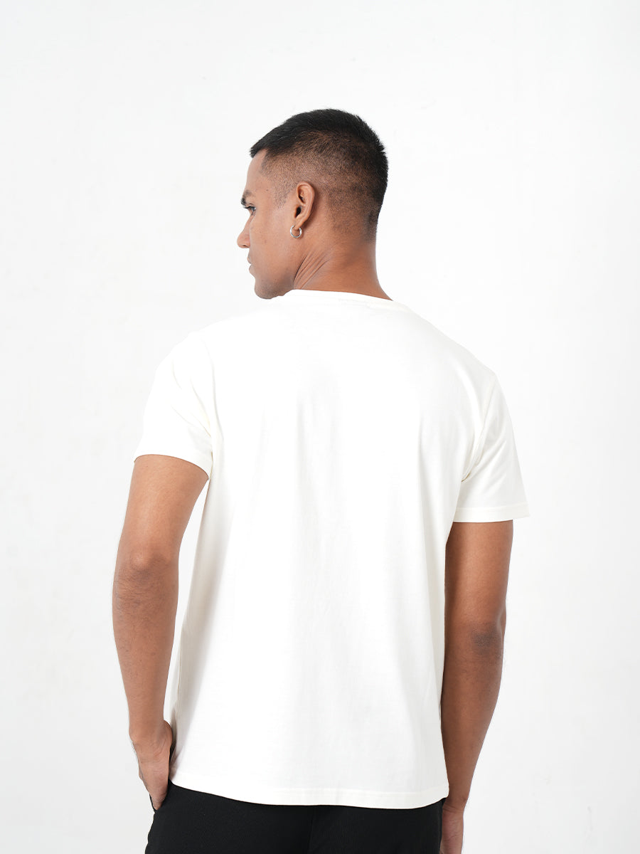 A man in a Monkstory Bamboo Cotton Crew Tee - Warm Ivory posing for a photo.