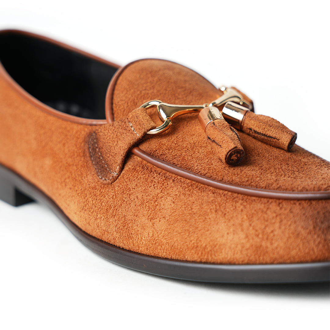 A rustic tan suede loafer, Monkstory Horse-bit Tasseled Slip-Ons - Rustic Tan, with timeless elegance.