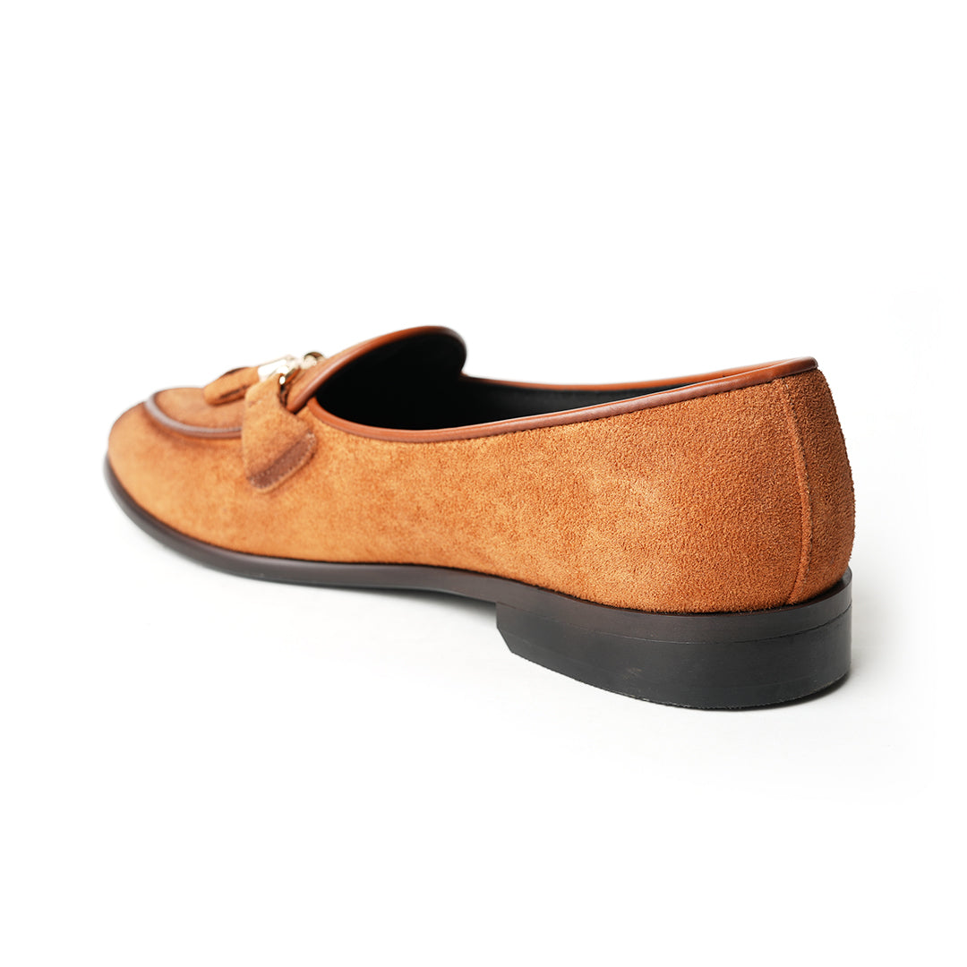A rustic tan suede loafer, Monkstory Horse-bit Tasseled Slip-Ons - Rustic Tan, with timeless elegance.