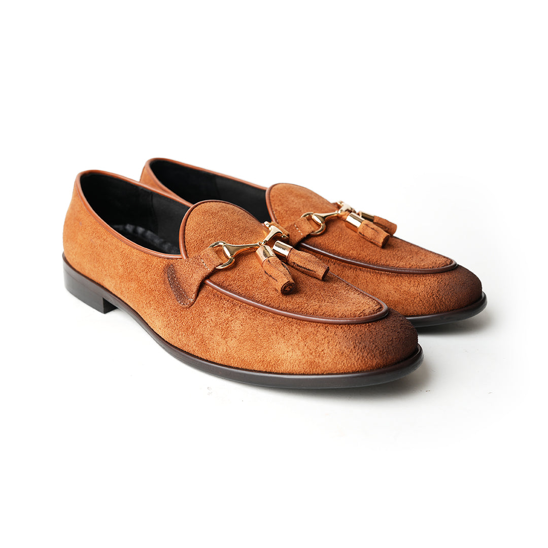 A rustic tan suede loafer, Monkstory Horse-bit Tasseled Slip-Ons - Rustic Tan, with timeless elegance.