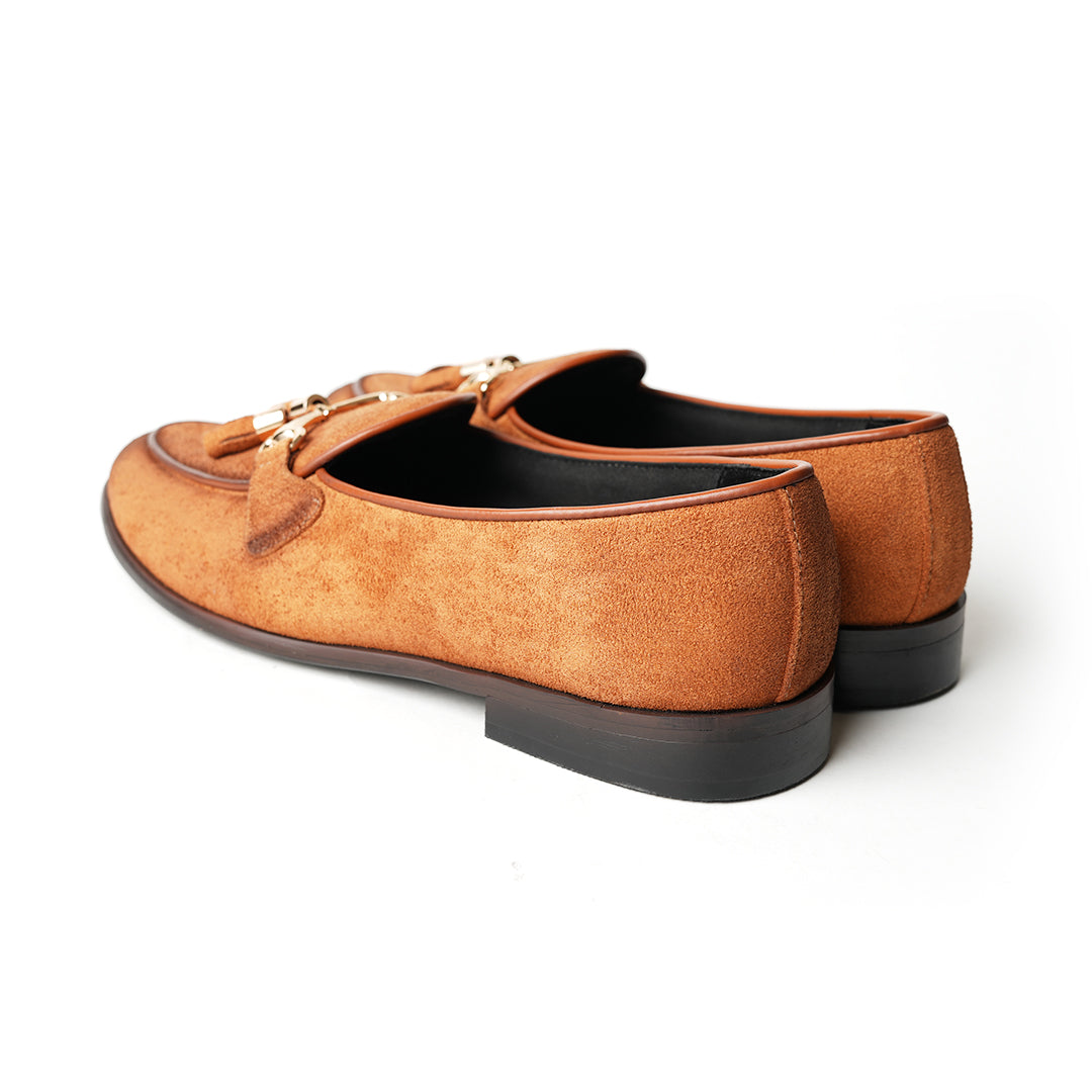A rustic tan suede loafer, Monkstory Horse-bit Tasseled Slip-Ons - Rustic Tan, with timeless elegance.