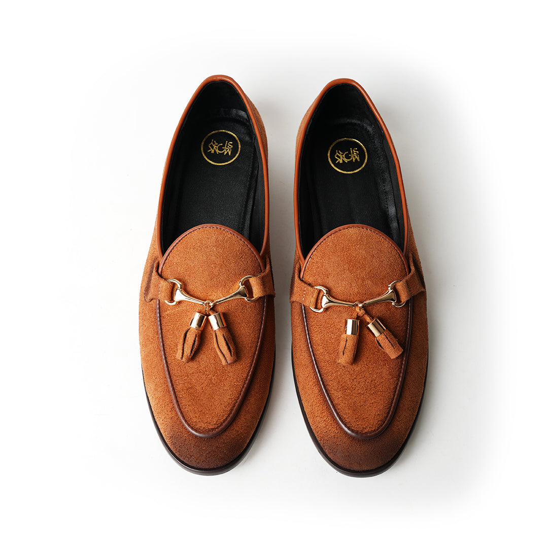 A rustic tan suede loafer, Monkstory Horse-bit Tasseled Slip-Ons - Rustic Tan, with timeless elegance.