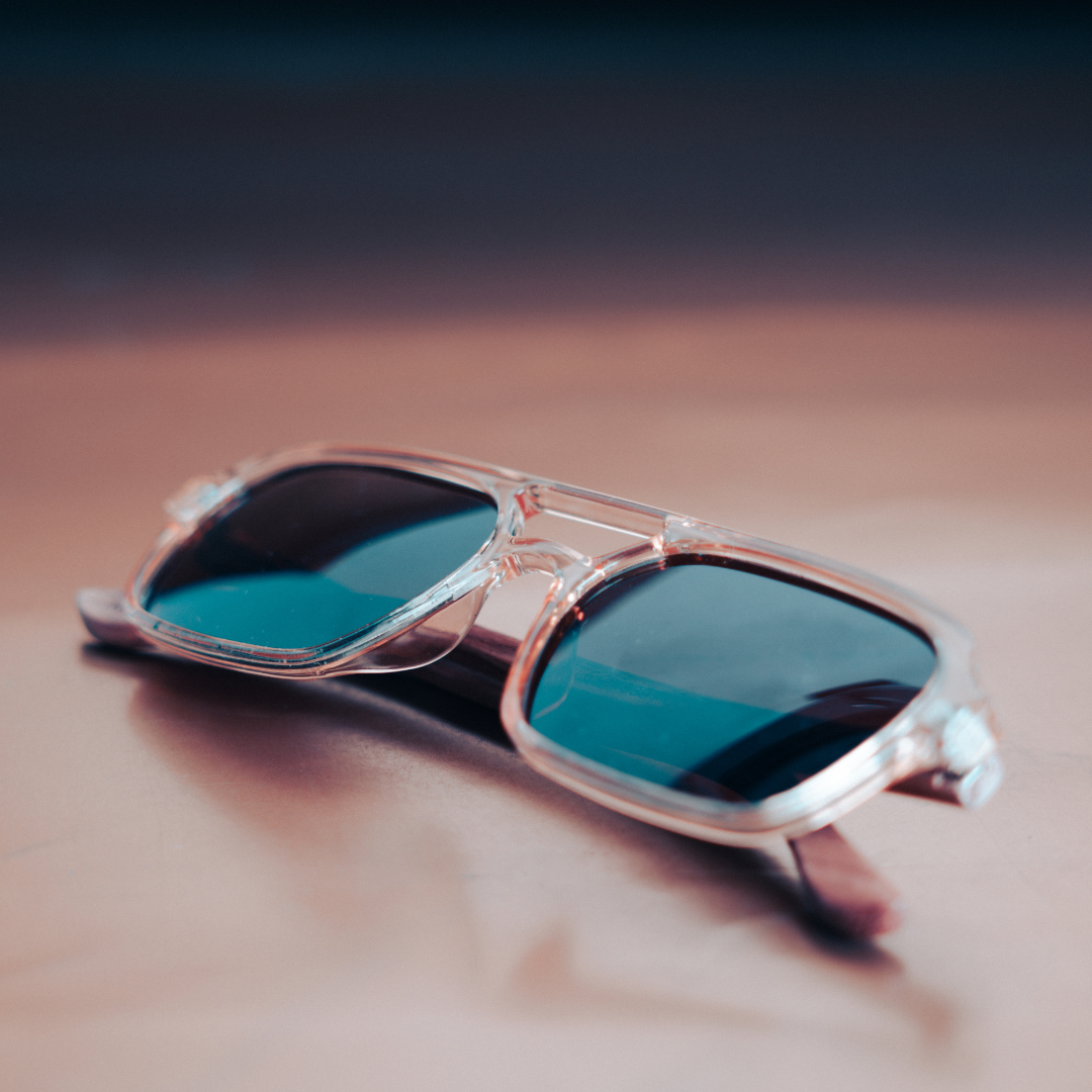 A pair of Monkstory Retro Wood Polarized Unisex sunglasses with transparent brown lenses on a white background.