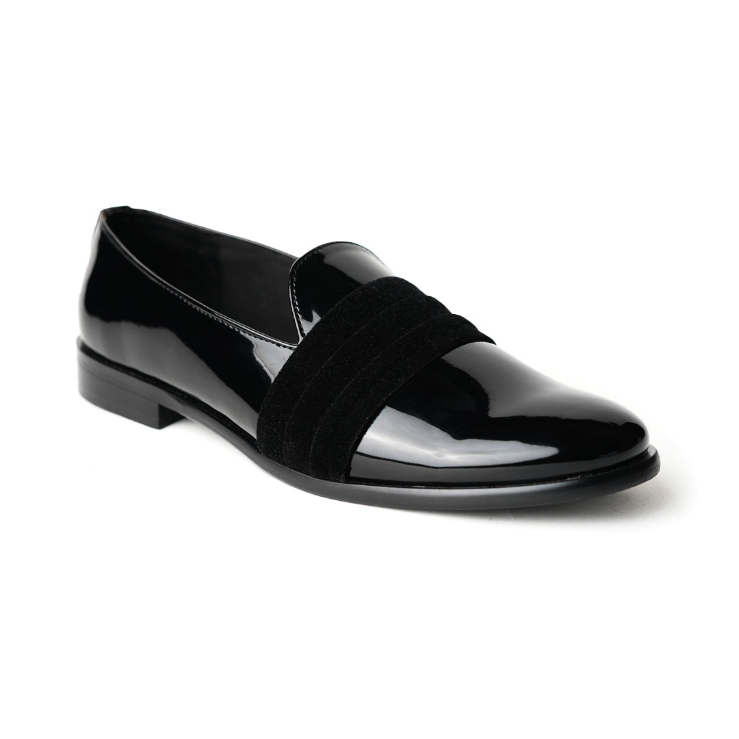 A black Tuxedo Slip-on with a patent leather finish and a bow on the side, by Monkstory.