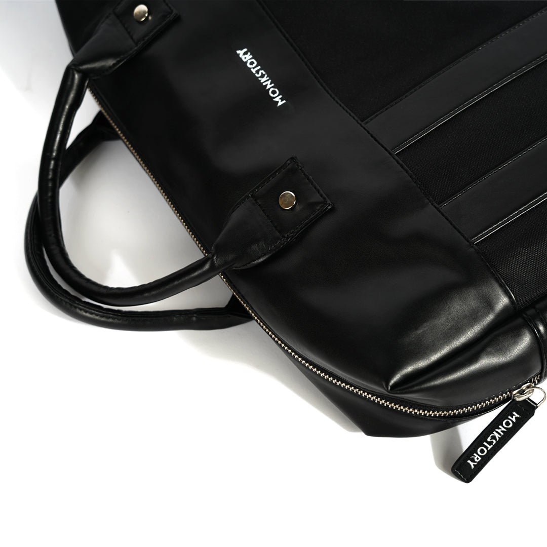 A Monkstory Timeless Laptop Bag - Black with storage options on a white background.