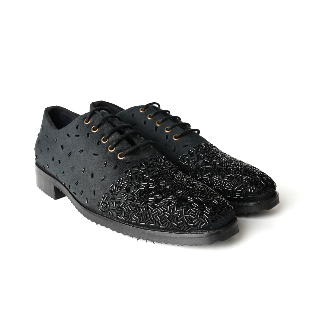 A stylish Monkstory Artisan Lace-Up - Black adorned with sequins, showcasing exquisite craftsmanship.