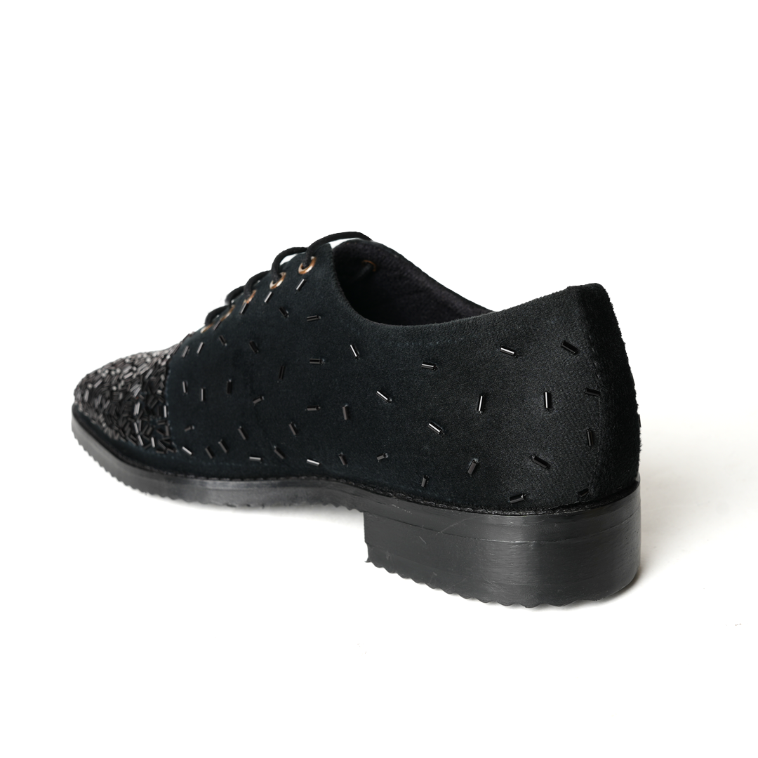 A stylish Monkstory Artisan Lace-Up - Black adorned with sequins, showcasing exquisite craftsmanship.