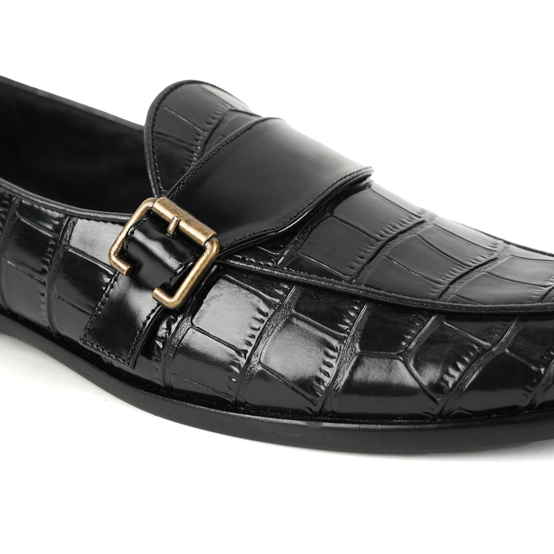 A sleek black Monkstory Croco Print Formal Shoes with a gold buckle.