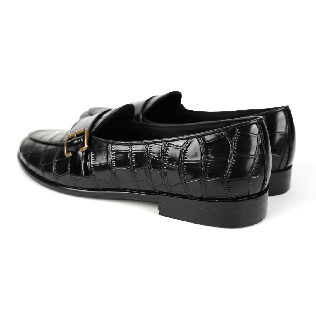 A sleek black Monkstory Croco Print Formal Shoes with a gold buckle.