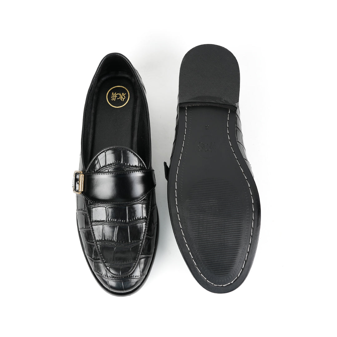 A sleek black Monkstory Croco Print Formal Shoes with a gold buckle.