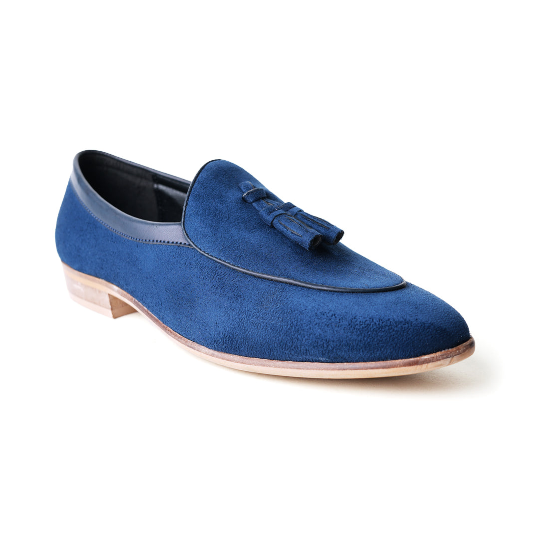 An eco-conscious blue suede Monkstory loafer with tassels, showcasing sustainability.