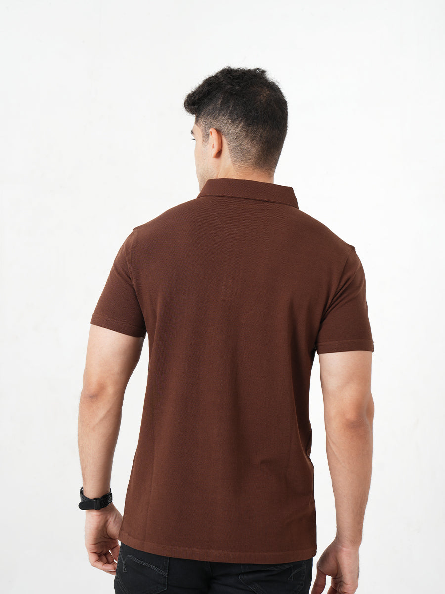 A man in a sophisticated Monkstory Bamboo Cotton Zip-Polo Tee, exuding comfort with his hands placed gently on his chest.