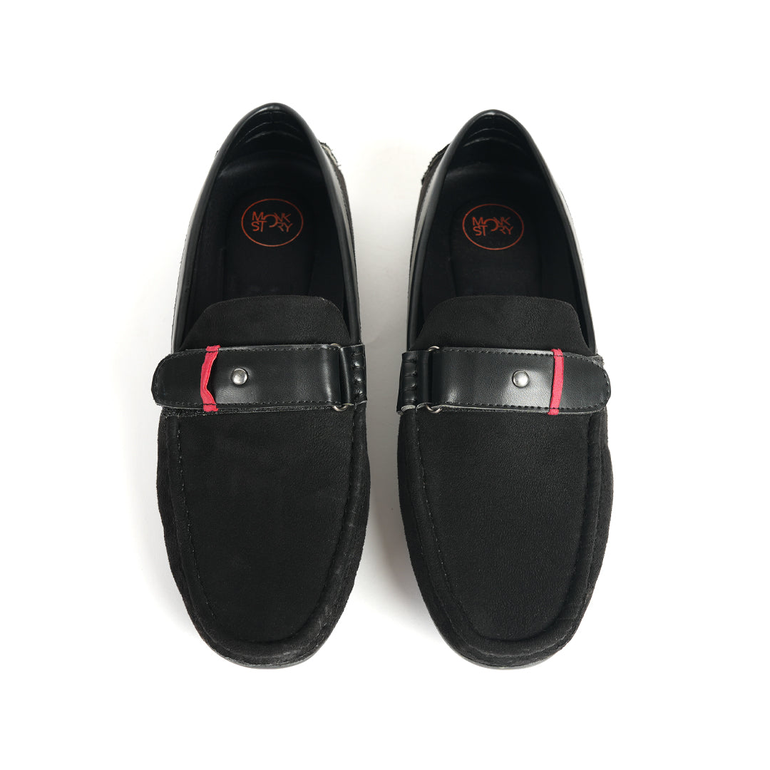 A comfortable Monkstory black loafer with a red stripe, perfect for driving.