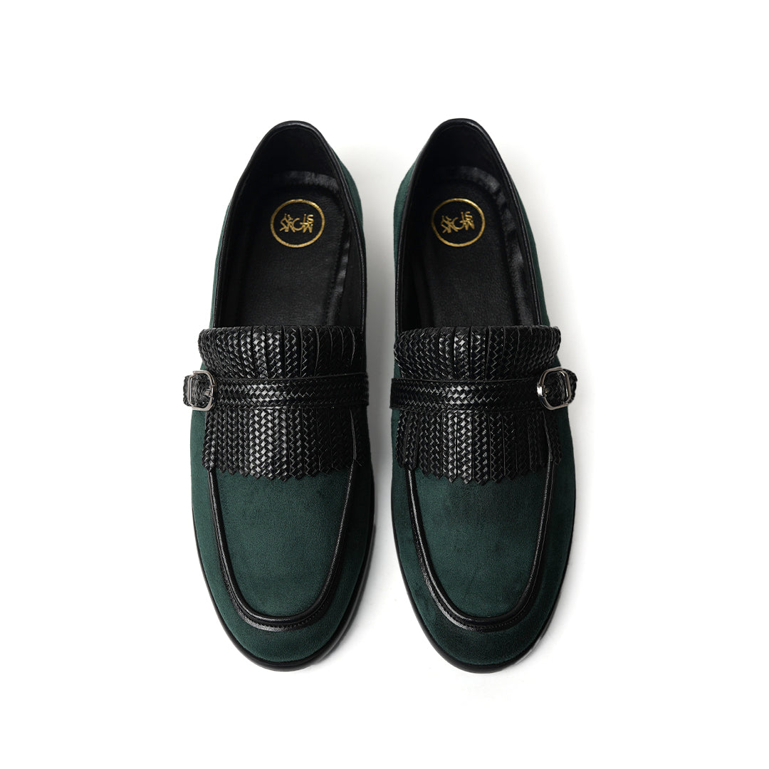 A Monkstory woven fringed slip-on with a bottle green suede and black buckle.