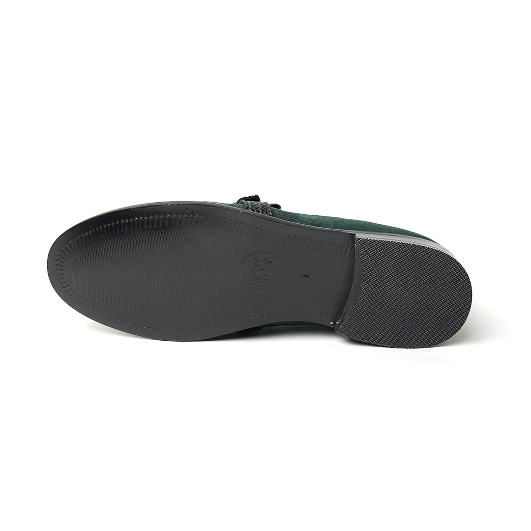 A Monkstory woven fringed slip-on with a bottle green suede and black buckle.