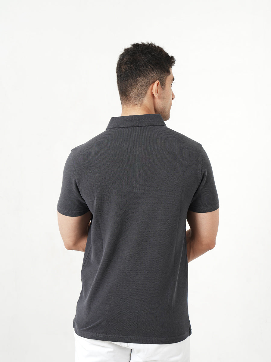 A man wearing a Monkstory Bamboo Cotton Zip-Polo Tee - Iron Grey shirt.