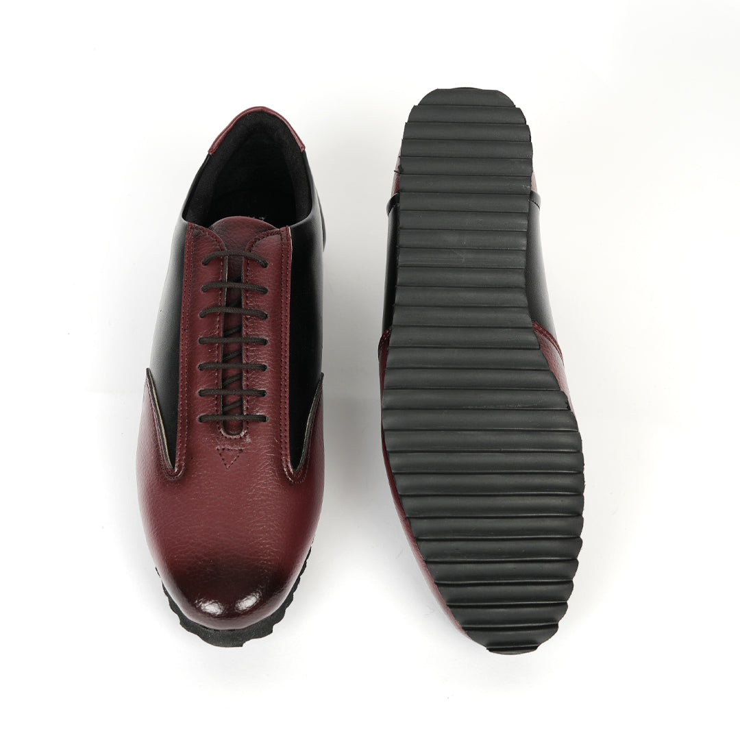 A fashionable Monkstory Dual Colour Smart Sneaker in burgundy and black leather that offers comfort.