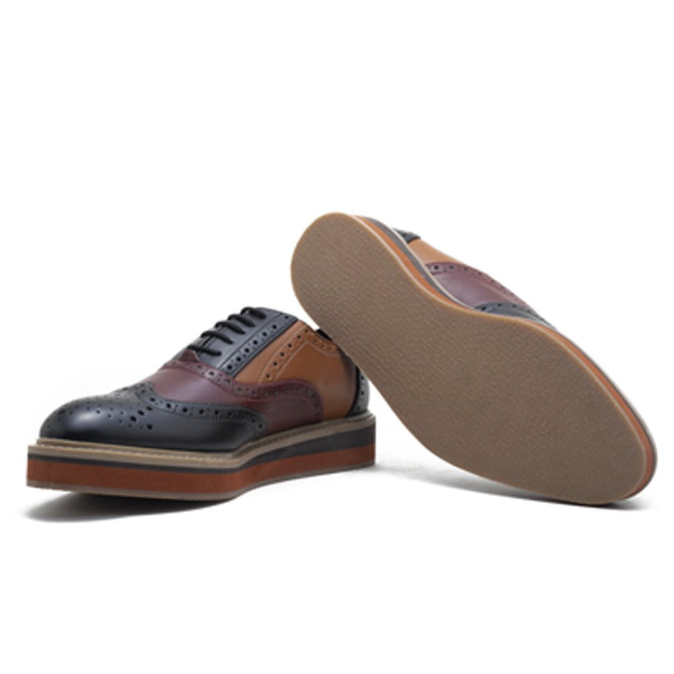 A fashion forward monkstory men's wingtip oxford shoe in black, orange and brown named Beverly Tricolour Brogues.