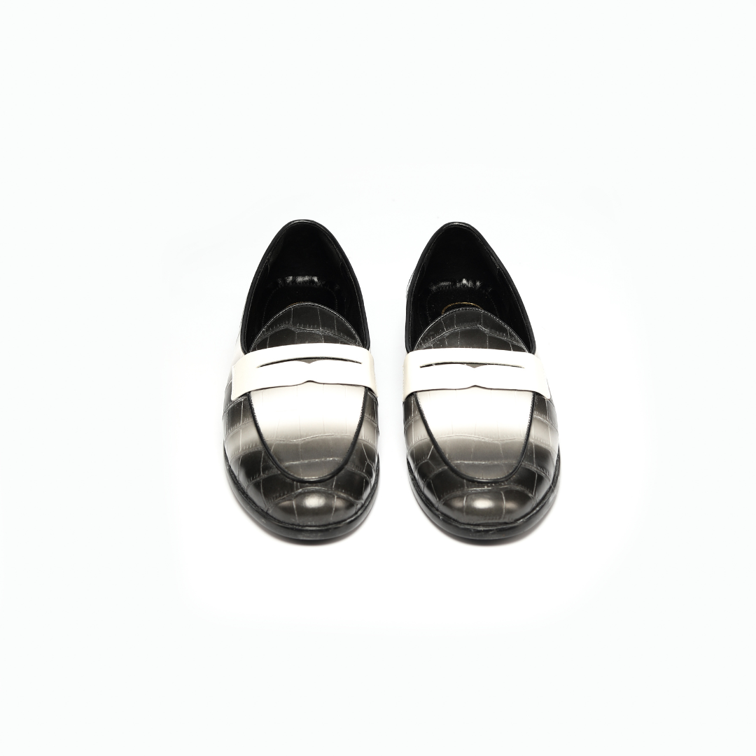 A black and white crocodile print Magnificos Faded Slip On loafer showcased on Instagram by Monkstory.