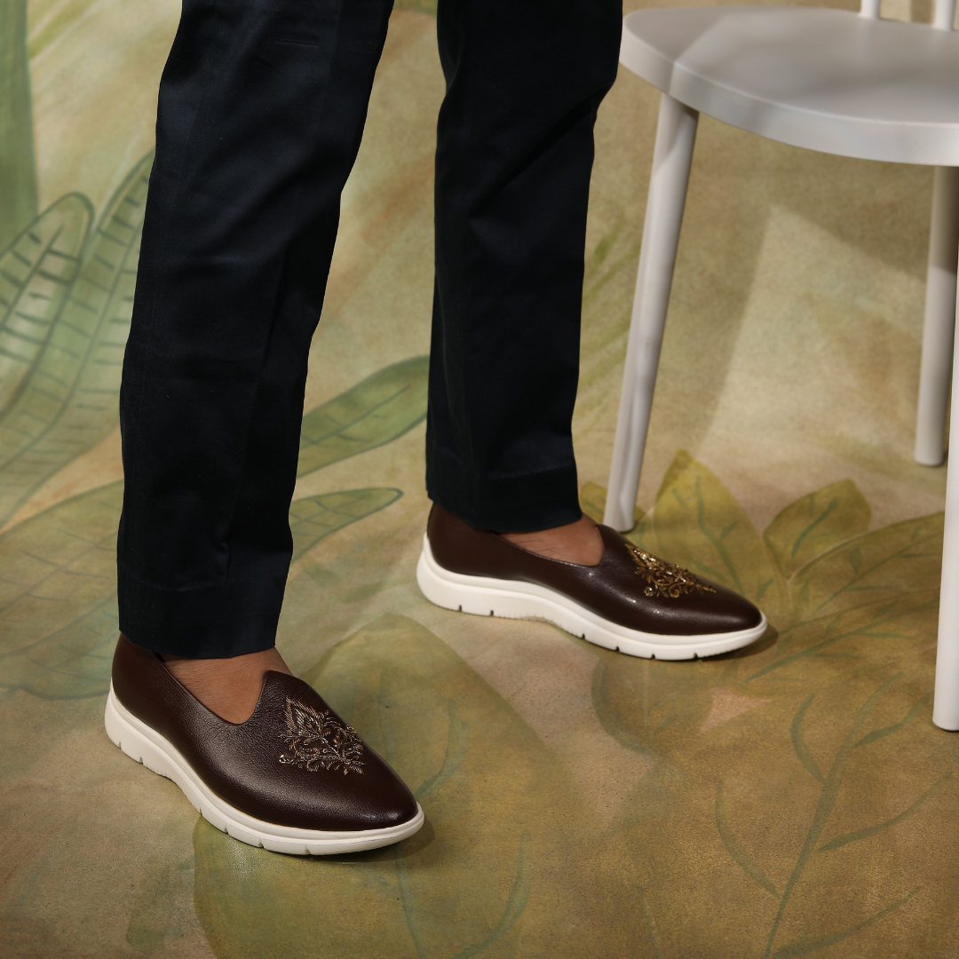 A brown leather slip on shoe with an embroidered design, perfect for those seeking an ethnic touch to their footwear collection - Monkstory ReMx Mojari Sneakers.