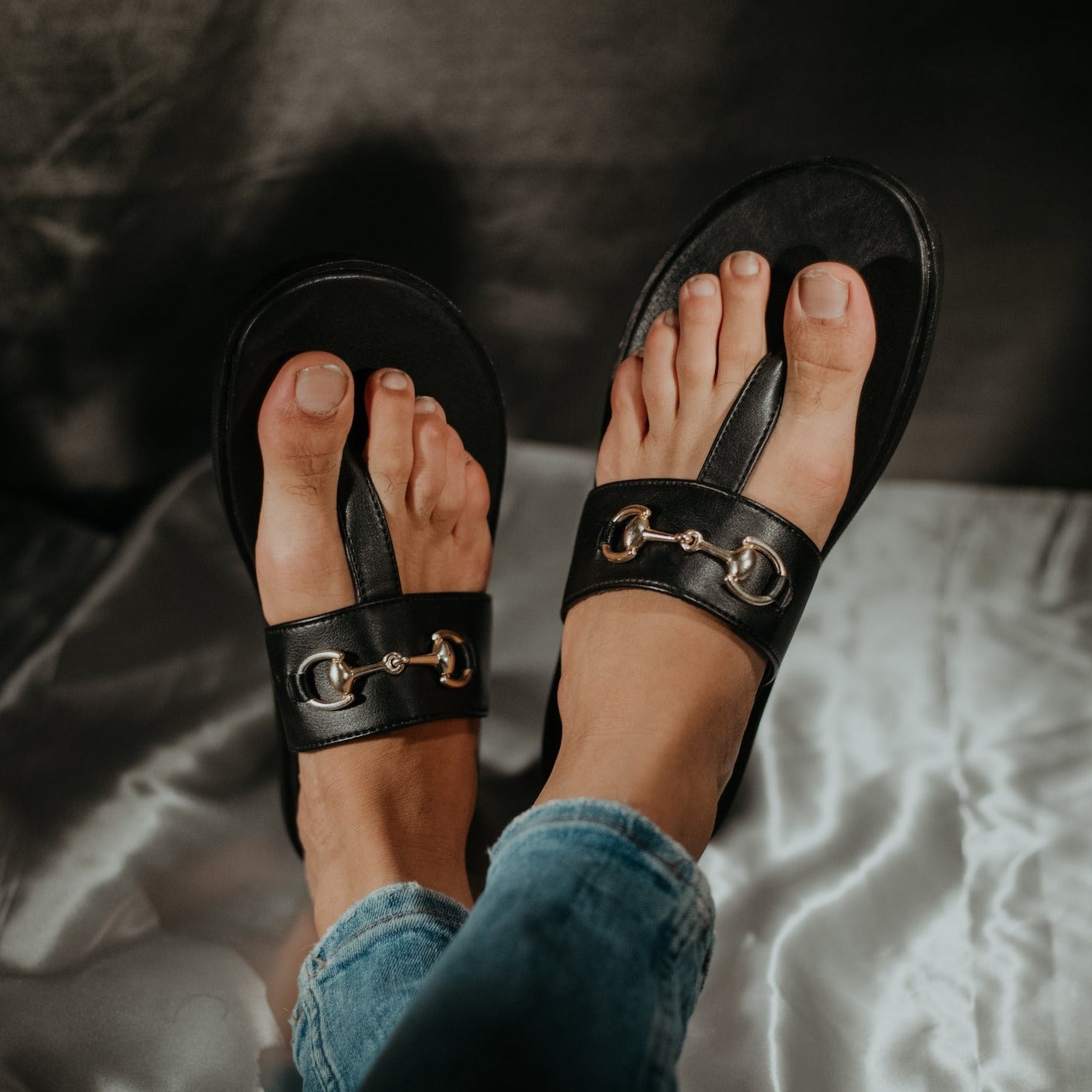A pair of Monkstory T-Rad Horsebit Sandals in black leather with a gold buckle.