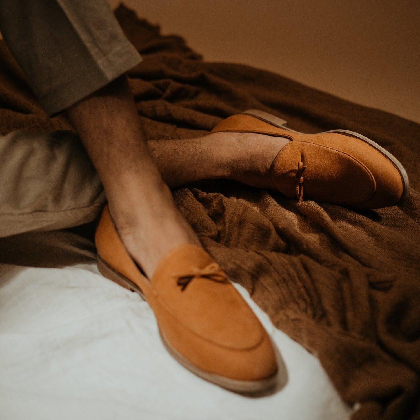 A sustainable monkstory tan loafer with a tassel on the toe, Wyld Faux-Suede Slip-Ons – Pastel Peach.